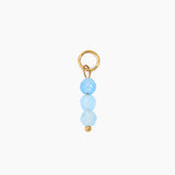 Blue bead charm on a white background