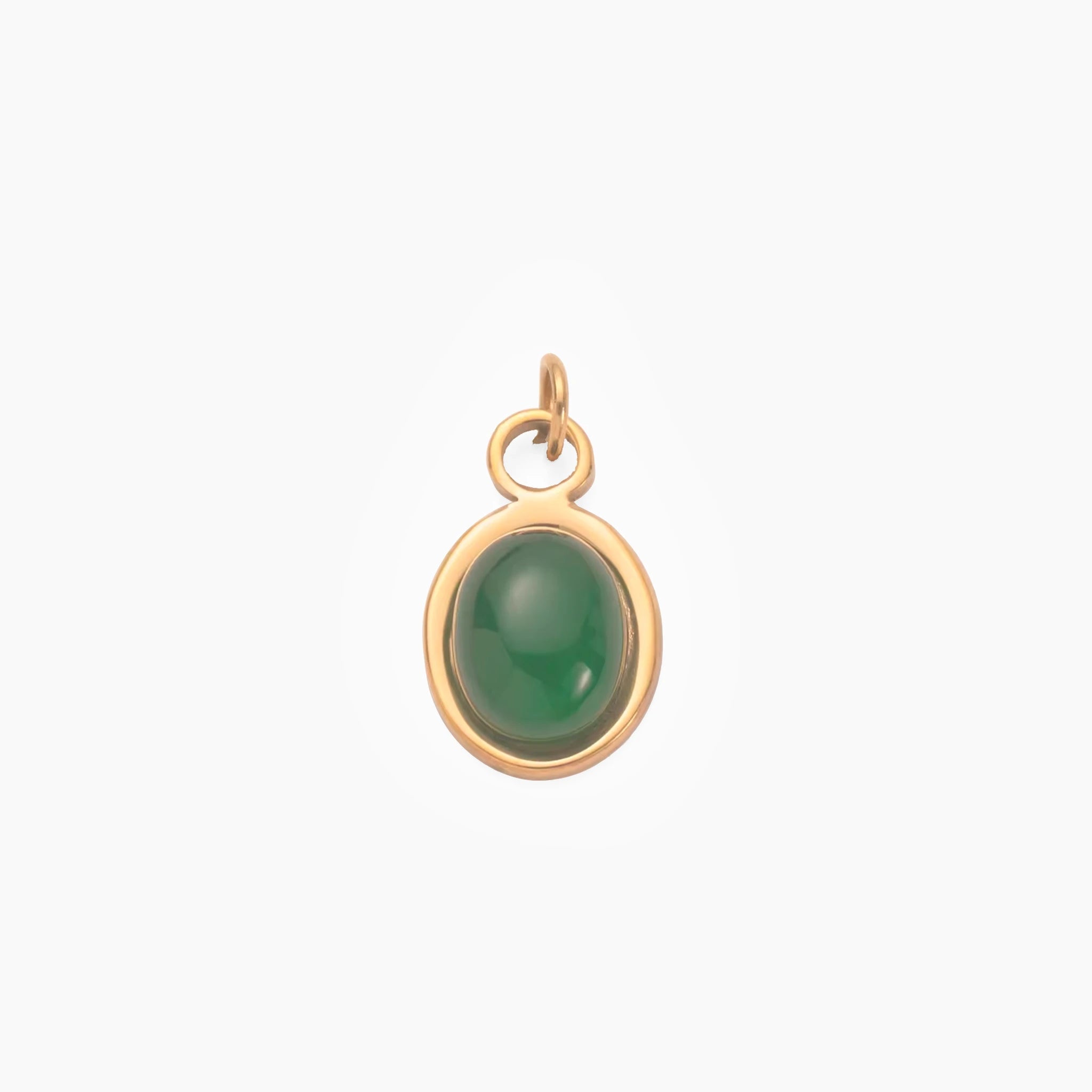 Golden pendant with a emerald green stone on a white background