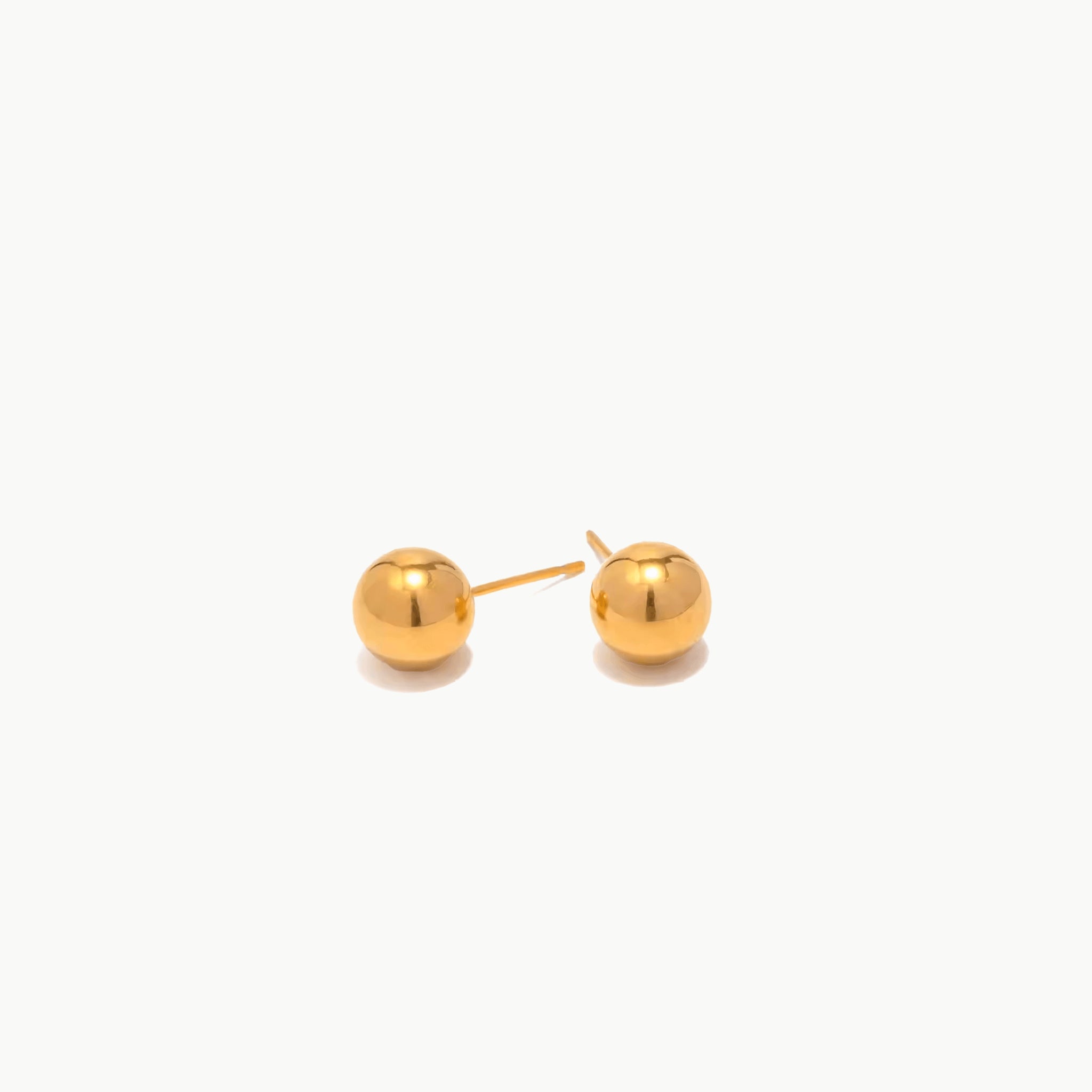 minimal golden stud earrings with polished ball design