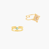 Two gold rings with decorative designs on a white background