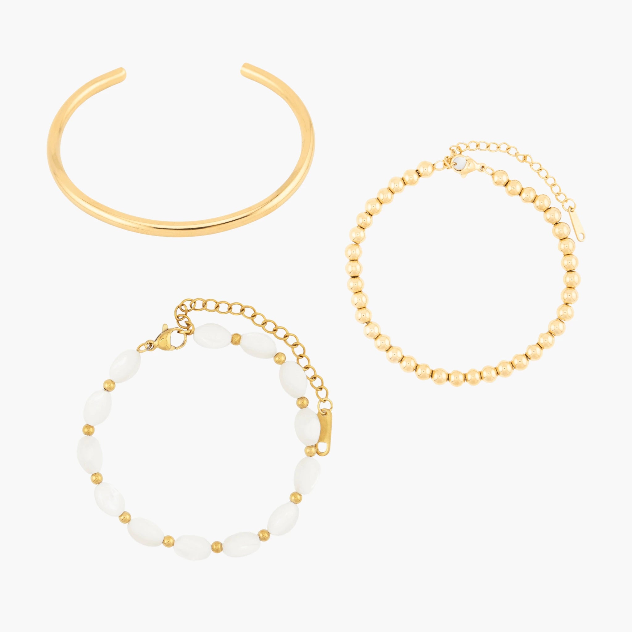 Set of golden bracelets on a white background