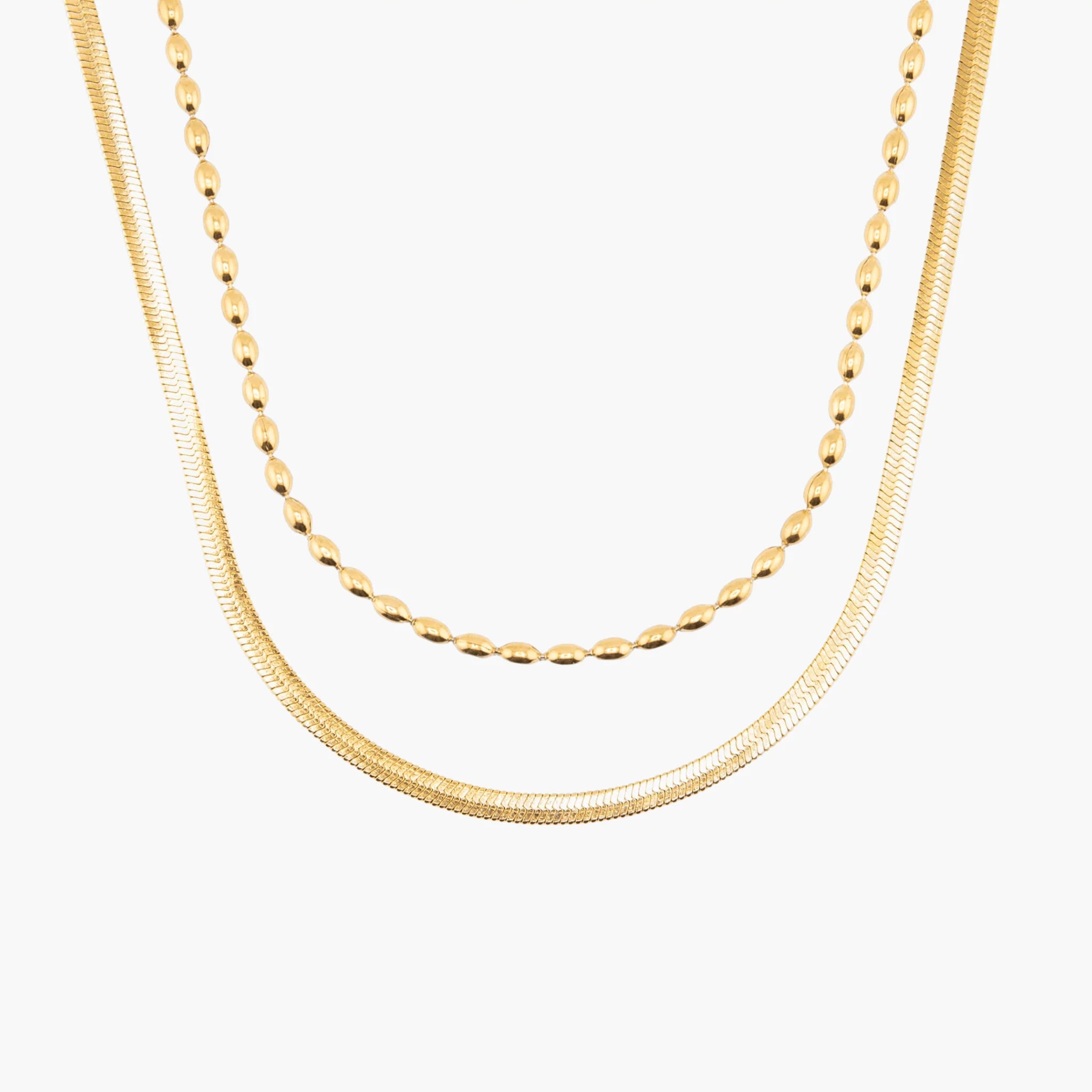 Two gold necklaces on a white background