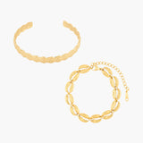 Two golden bracelets on a white background