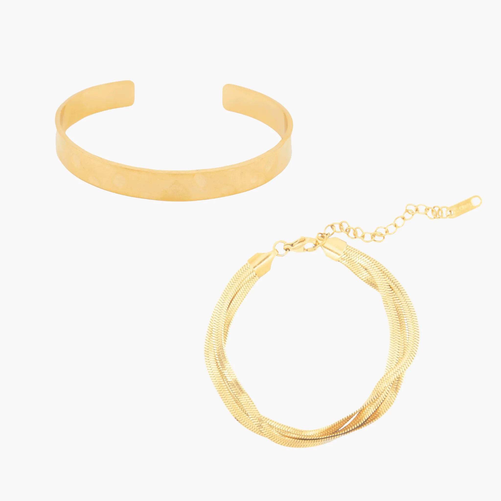 Two golden bracelets on a white background