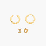 Gold hoop earrings and XO letter earrings on a white background