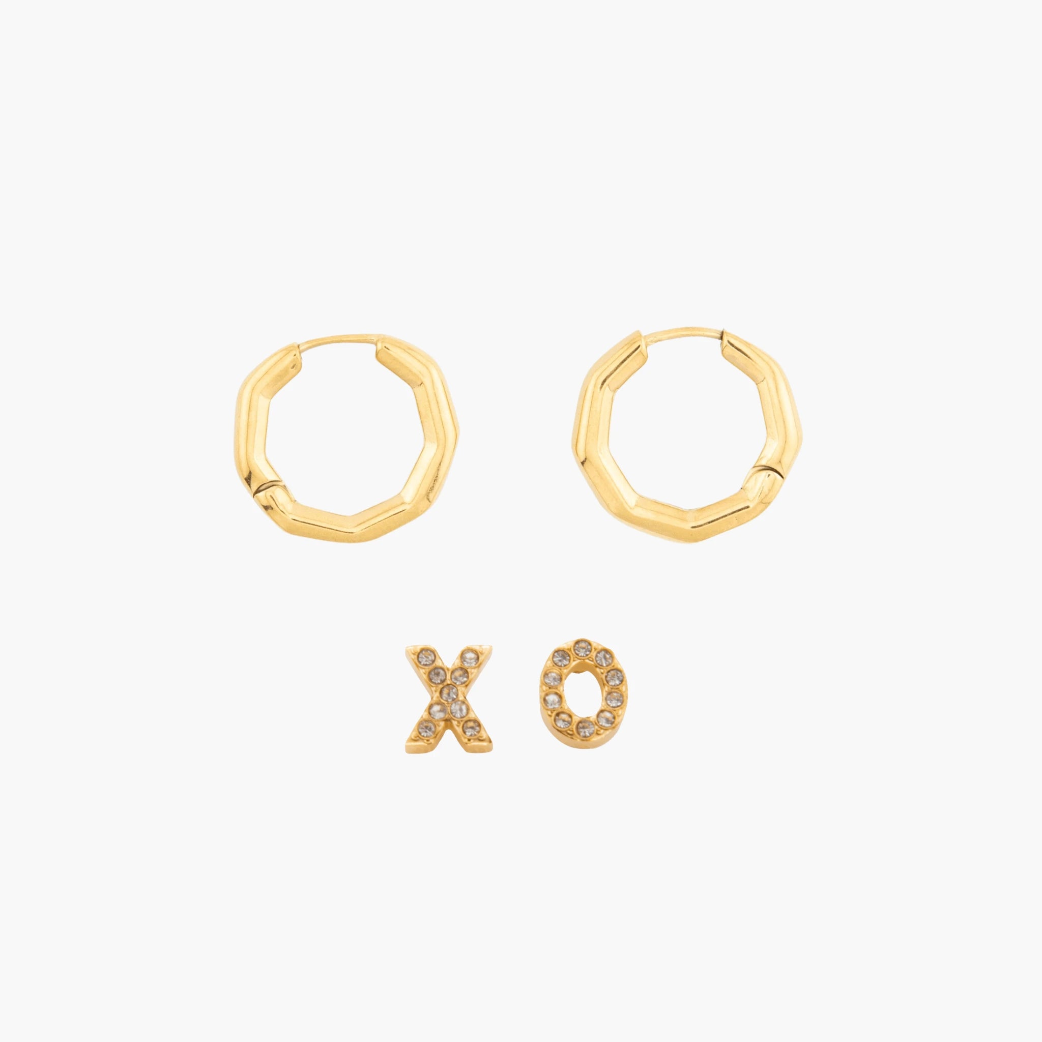 Gold hoop earrings and XO letter earrings on a white background