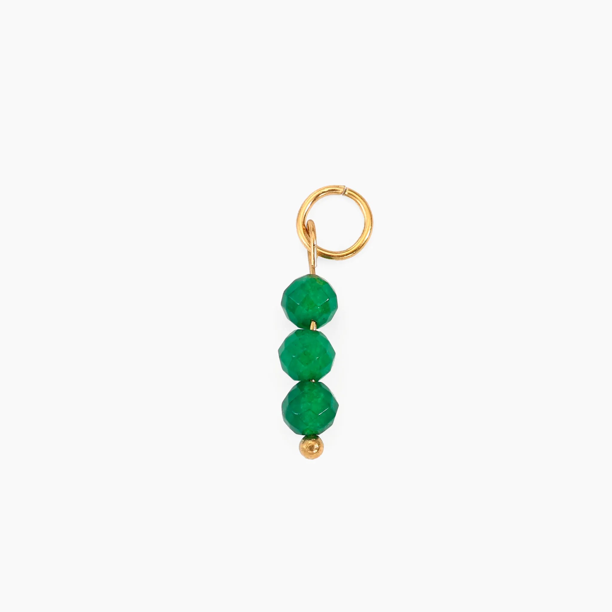 Golden charm with green beads on a white background