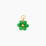Green flower-shaped charm with gold accents on a white background