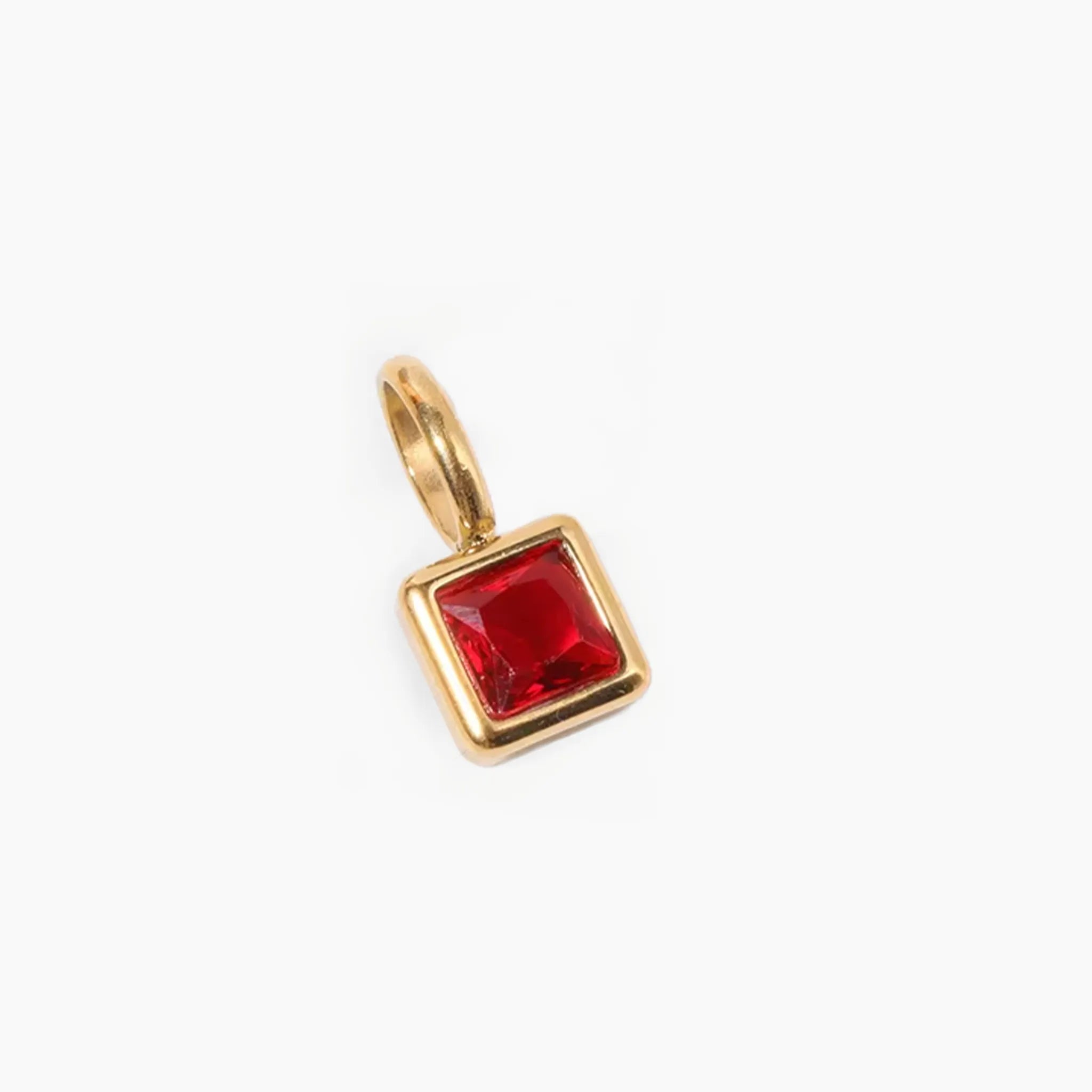 January birthstone charm, golden pendant with a red gemstone on a white background