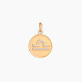 Golden pendant with libra zodiac symbol on a white background