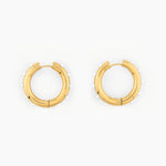 pair of gold hoop earrings with small white pearl accents