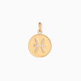 Golden pendant with pisces zodiac symbol on a white background