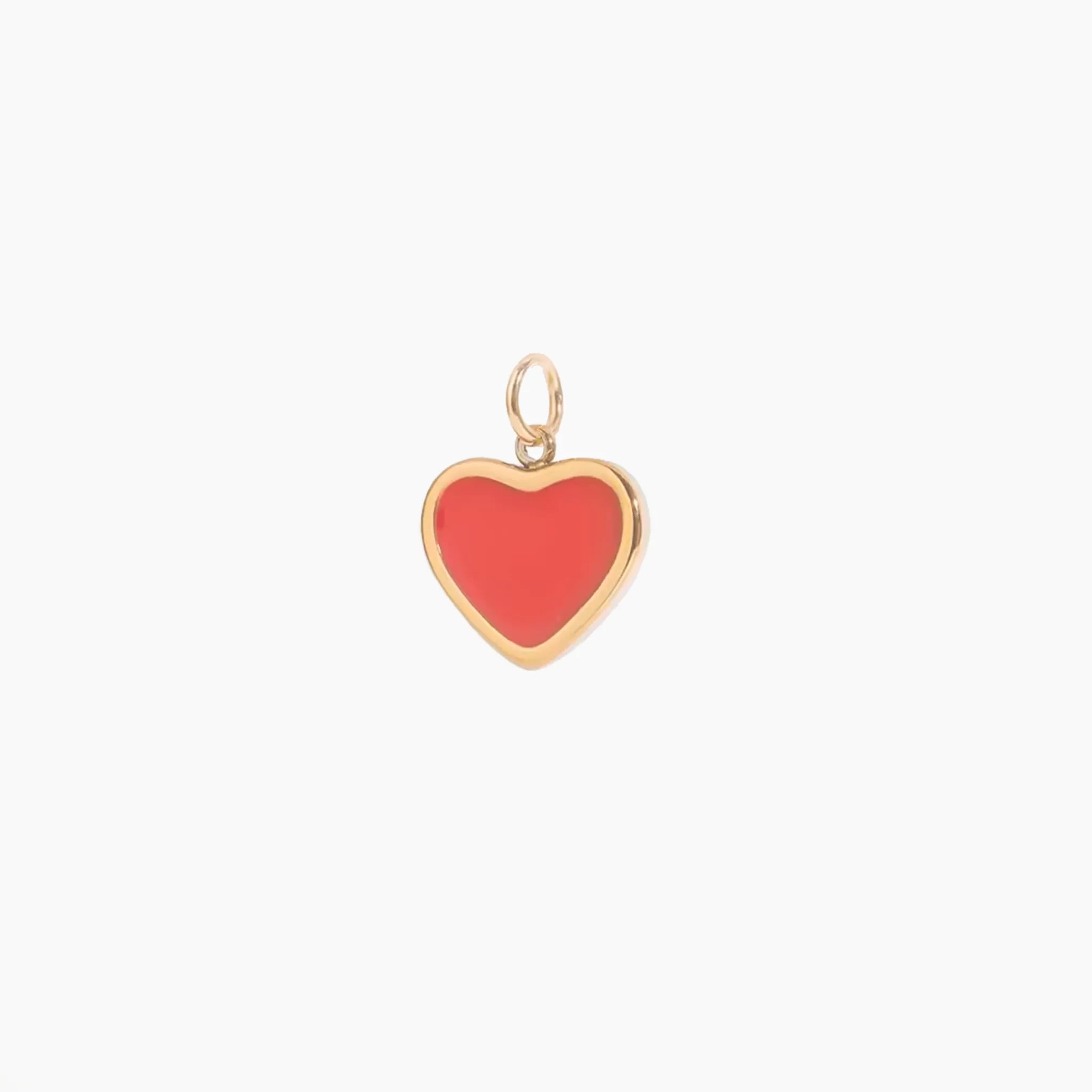 Heart-shaped pendant with red center and golden border on a white background