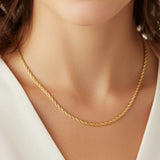 Close-up of a woman wearing a bold twisted rope chain necklace