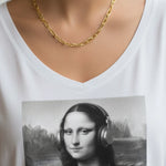 A woman wearing a gold textured link necklace