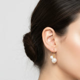 Pearl earring worn by a person with a neutral background